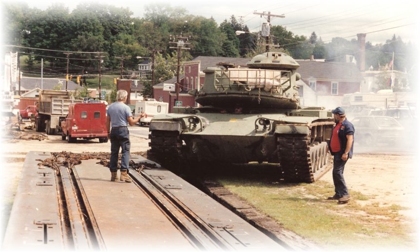 Louis P. Cote, Inc. riggers load a M-60 Tank onto a railcar for a defense contractor in 1991