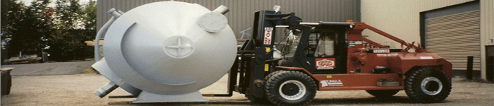 Louis P. Cote, Inc.'s riggers use a forklift to move a piece of heavy machinery