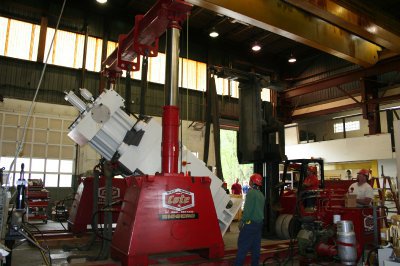 Louis P. Cote, Inc.'s riggers use a gantry system and Versa-Lift forklift to rotate a piece of heavy machinery in their Goffstown NH warehouse.