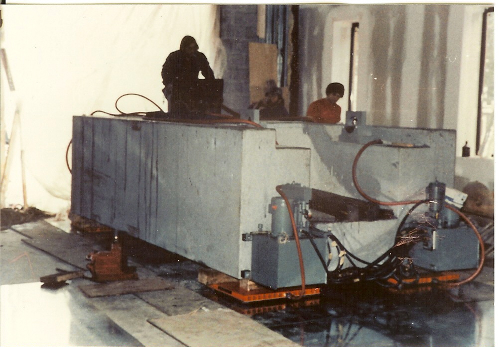 Louis P. Cote, Inc. riggers use an air caster system to move a large piece of heavy machinery.