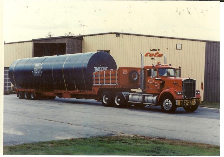 A large tank is loaded and prepared for transport outside of Louis P. Cote, Inc.'s Goffstown NH Headquarters.