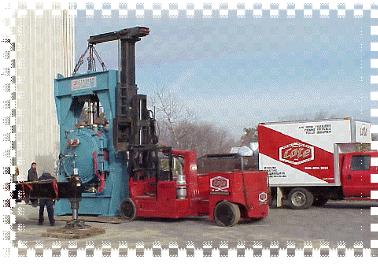 Louis P. Cote, Inc. riggers use a Versa-Lift forklift to move heavy machinery.