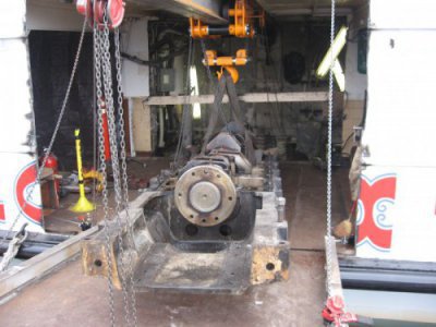 Louis P. Cote, Inc.'s riggers move the crankcase towards the dock inside of the MS Mount Washington Cruise Ship on Lake Winnipesaukee in Laconia NH
