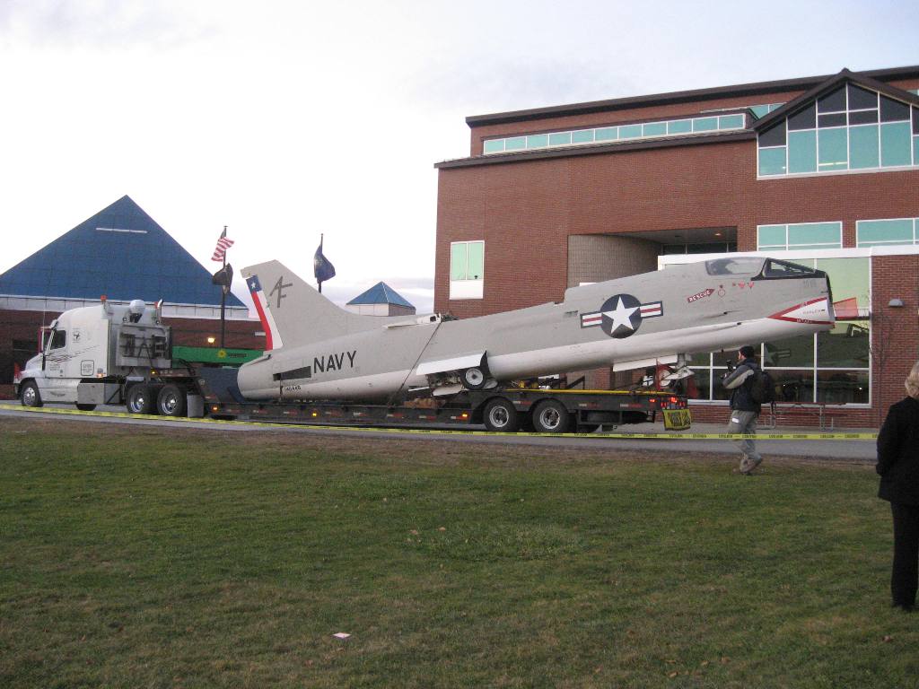 Louis P. Cote, Inc.'s riggers prepare to unload the body of a 1956 U.S. Navy XF8U-2 Crusader jet into the McAuliffe-Shepard Discovery Center in Concord NH