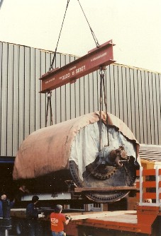 Louis P. Cote, Inc.'s riggers use a crane to lift a large piece of equipment.