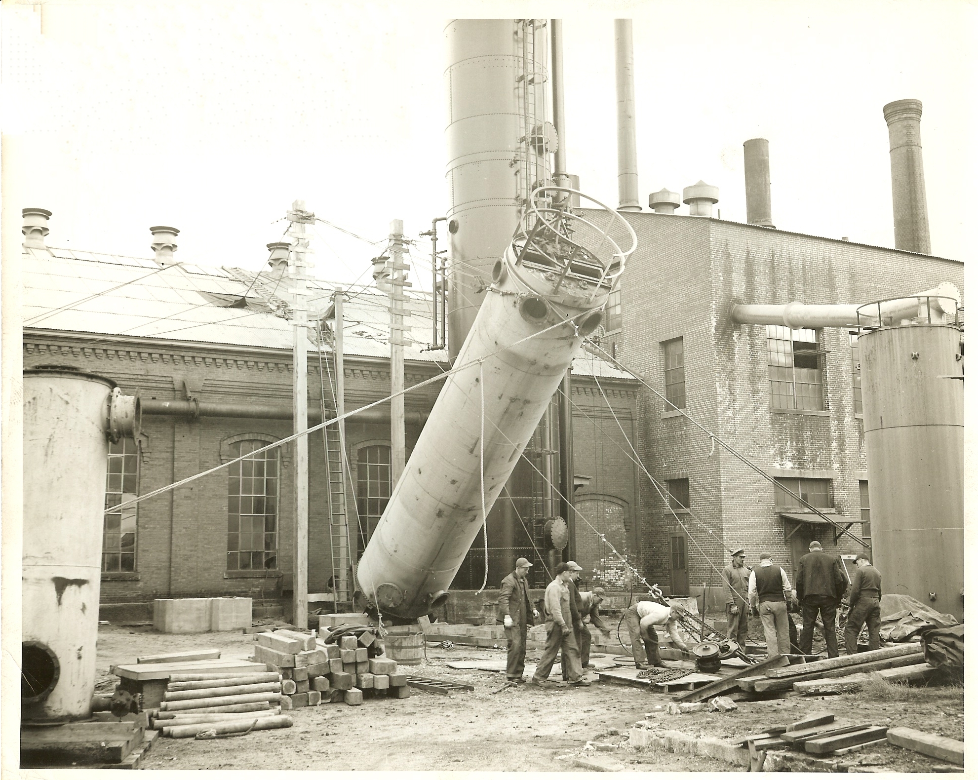 Louis P. Cote, Inc.'s riggers hoist a large tank into it's vertical position.