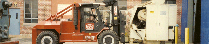 Louis P. Cote, Inc.'s riggers use a forklift to move a piece of heavy machinery