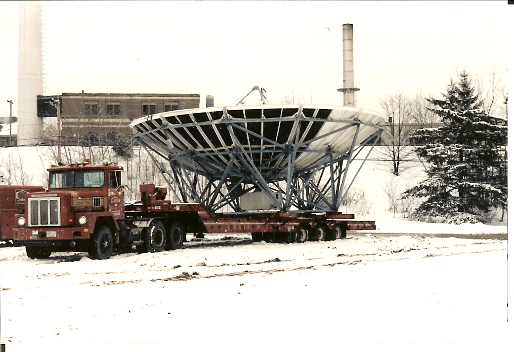 Louis P. Cote, Inc.'s heavy haul truckers transport a large radio dish and over-sized load.